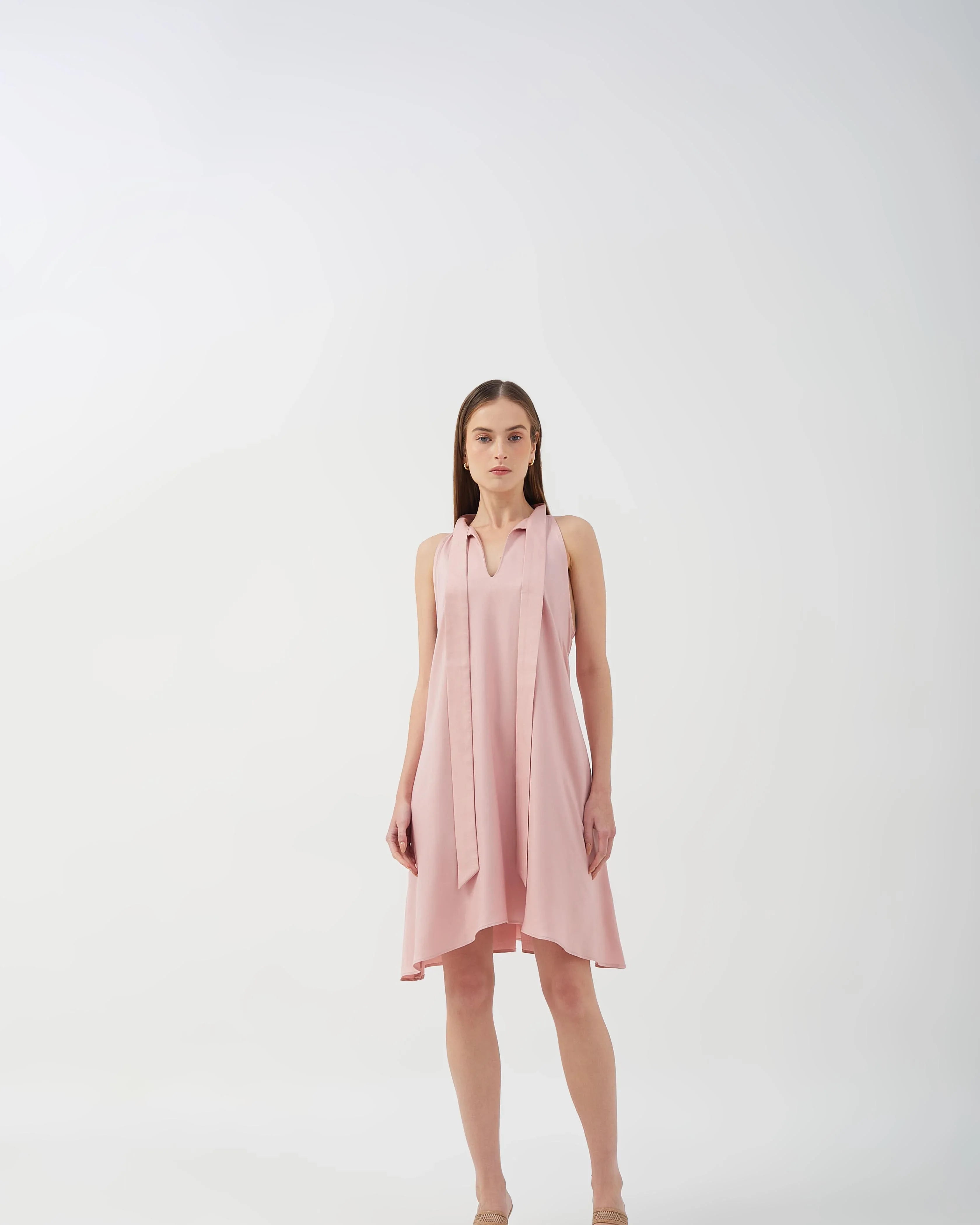 A-line dress with bow tie neck and asymmetrical hem, perfect for casual styling.