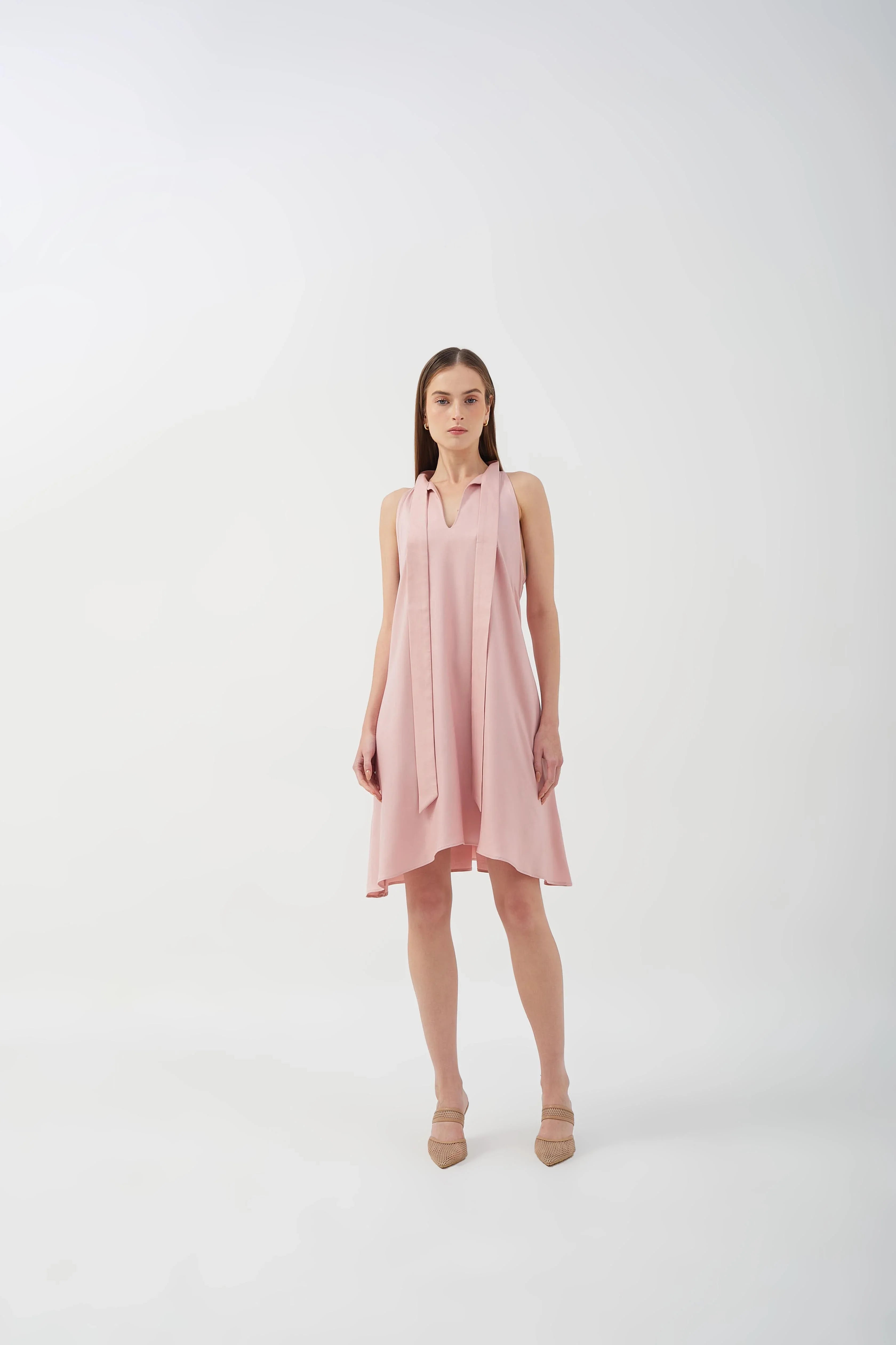 A-line dress with bow tie neck and asymmetrical hem, perfect for casual styling.
