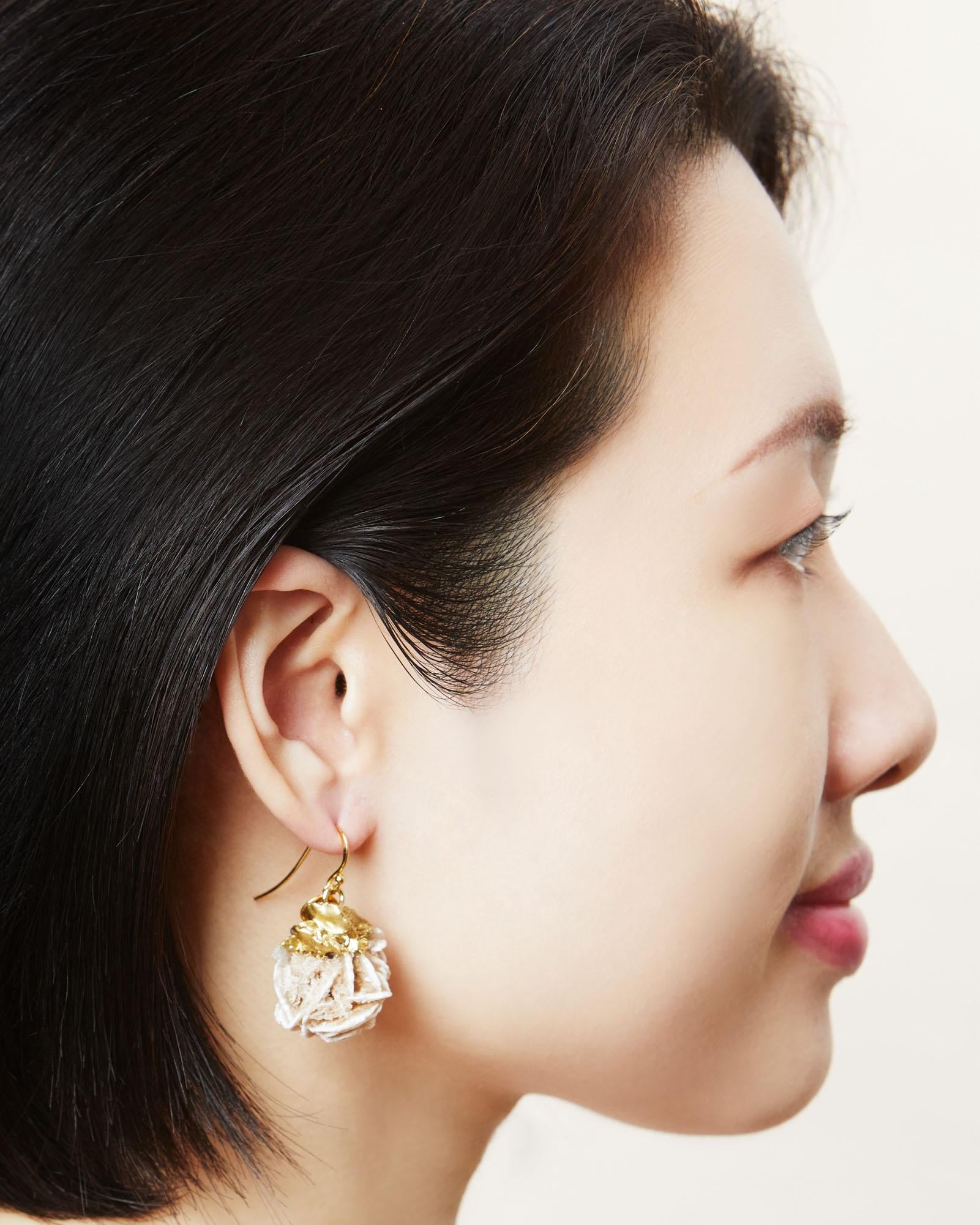 Large natural crystal hook earrings in rose gold.