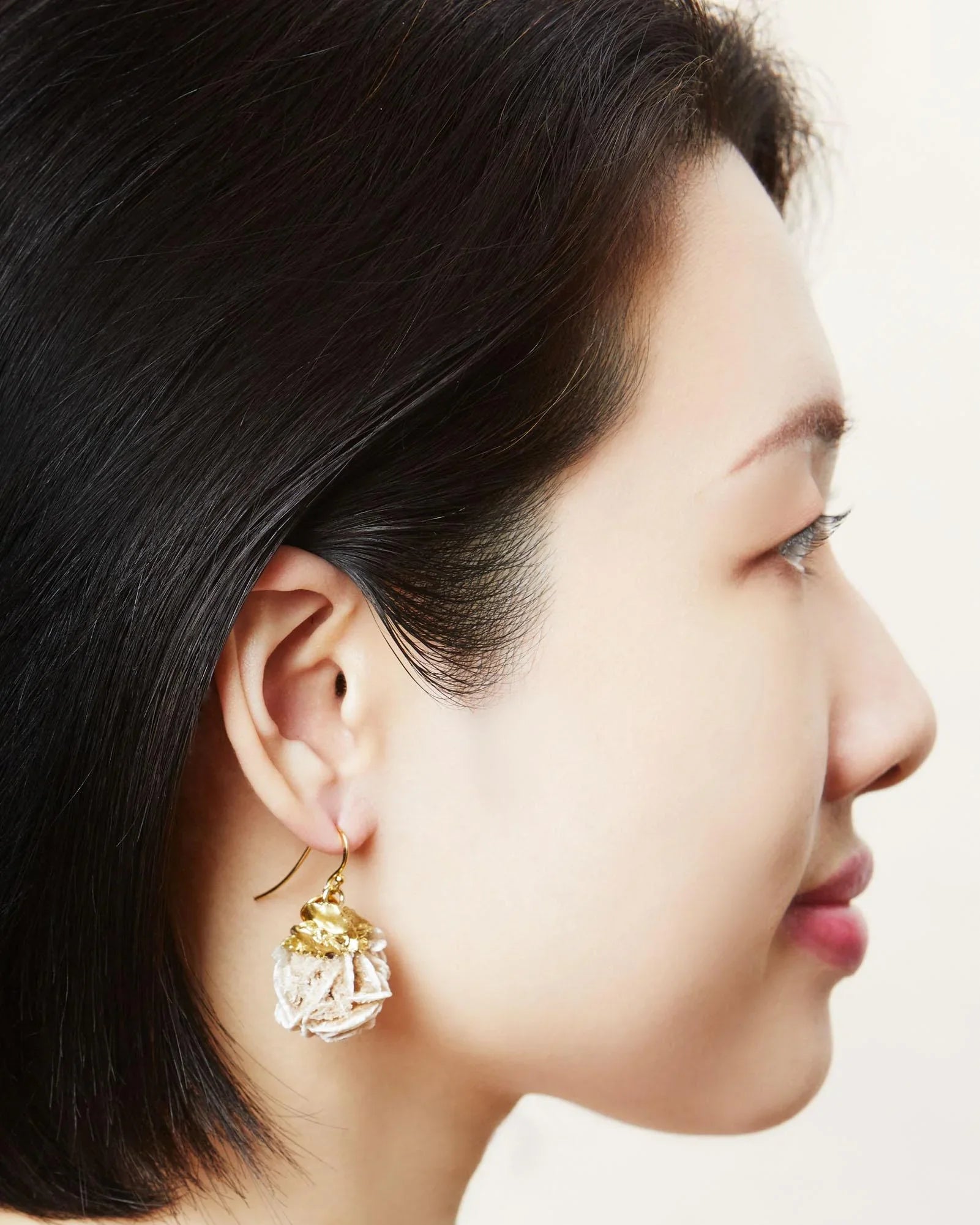 Large natural crystal hook earrings in rose gold.