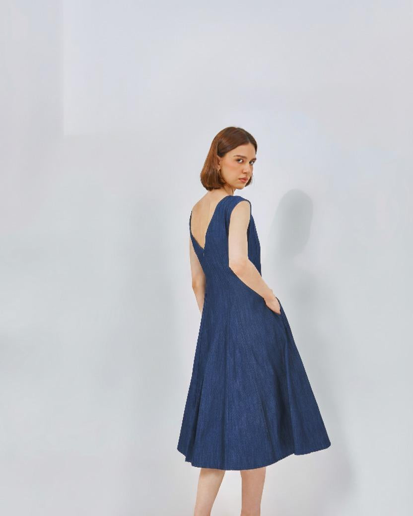 Fit and flare dress in denim with boat neckline and flared skirt, ideal for casual styling.