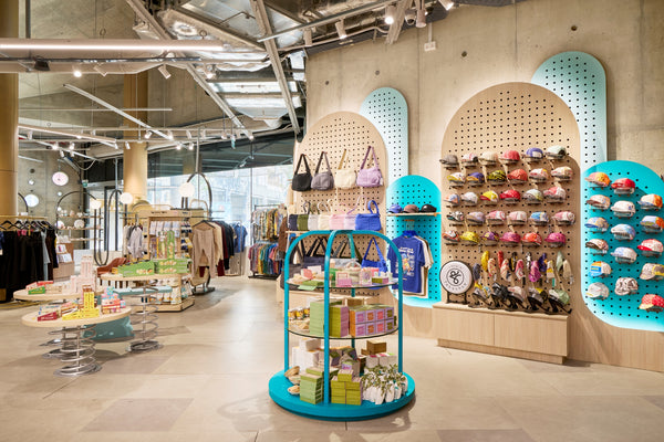 Colourful shelves and wall displays holding bags, caps and small gifts at DORS