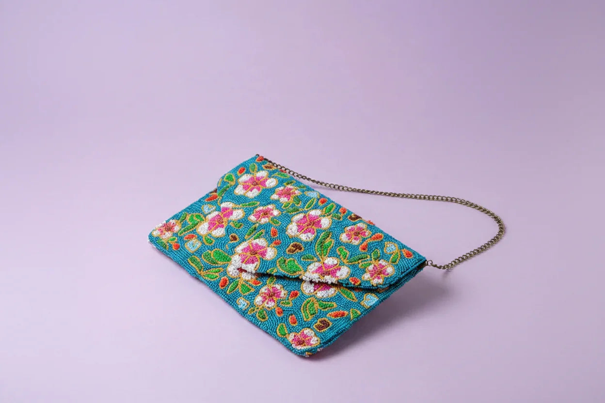 Decorative clutch bag with floral patterns on a light purple background